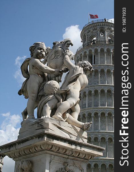 The statue Campo dei Miracoli infront of the leaning tower of Pisa in Italy.