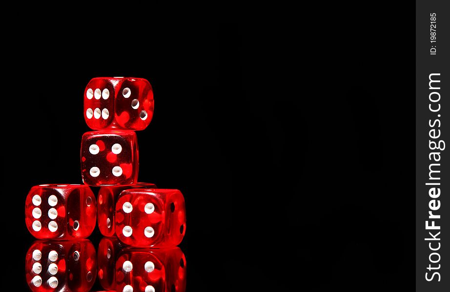 Red playing dices on black background