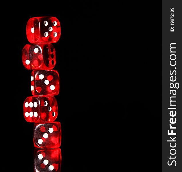 Red playing dices on black background