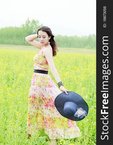 Charming Asian beauty posing in summer field. Charming Asian beauty posing in summer field.