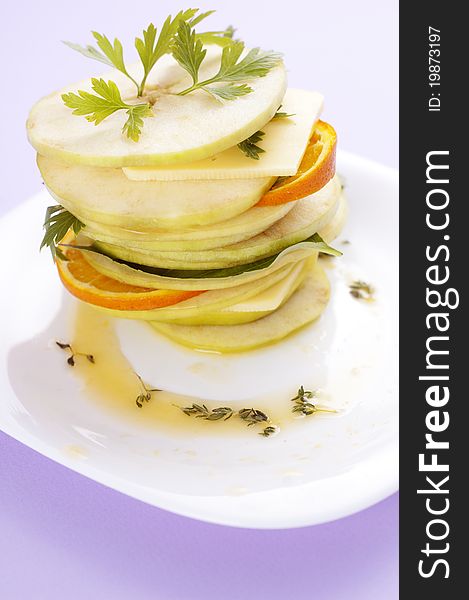 Sliced apple with herbs and orange