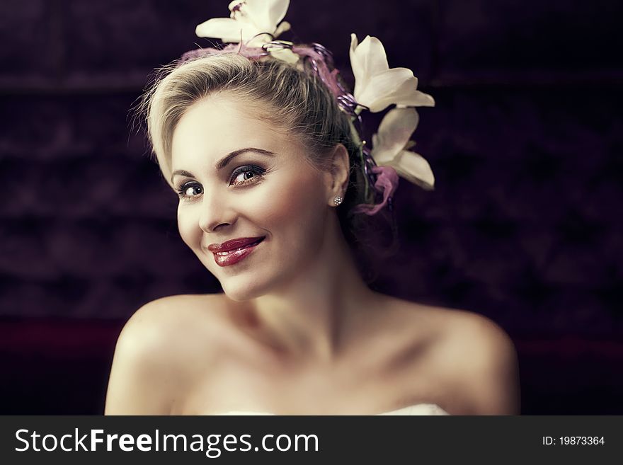 Portrait of young beautiful blond woman with stylish hair-do