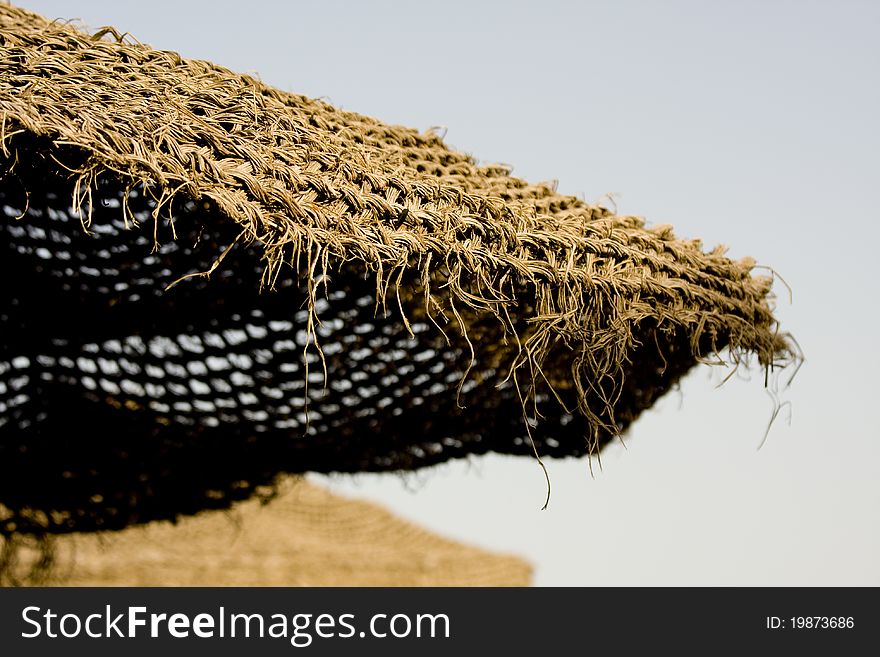 Straw umbrella on the beach sun protecting