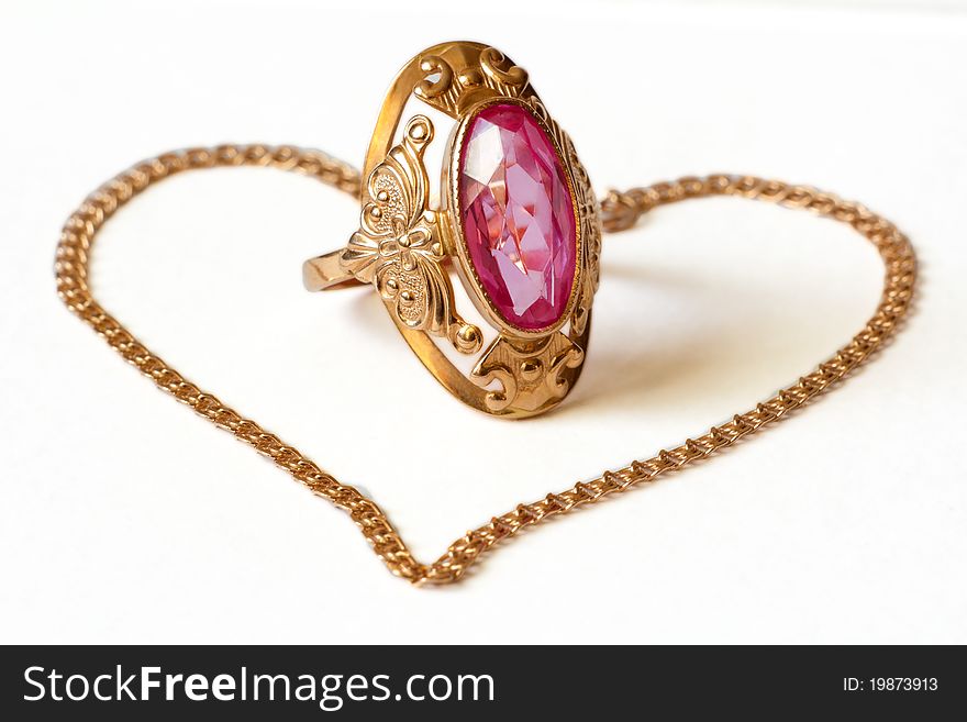 Golden ring with amethyst and bracelet on white background. Golden ring with amethyst and bracelet on white background