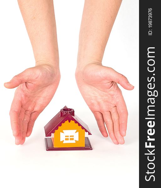 Hands and little house on white background