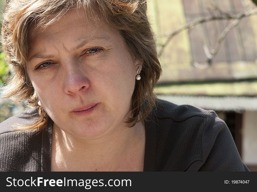 Portrait of mature woman sitting in countryside. Portrait of mature woman sitting in countryside