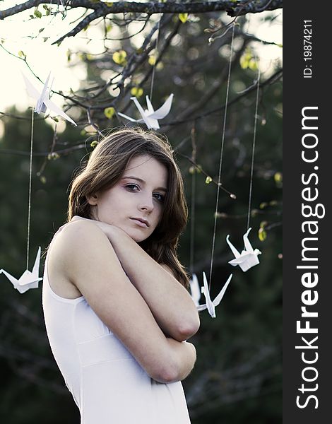 A portrait of a young woman standing in the park