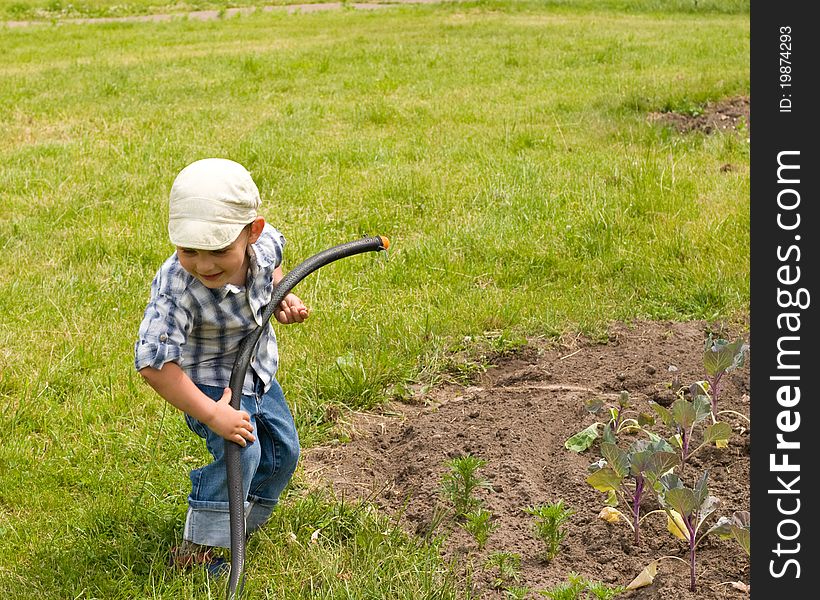 Boy Playing With Garden Hose