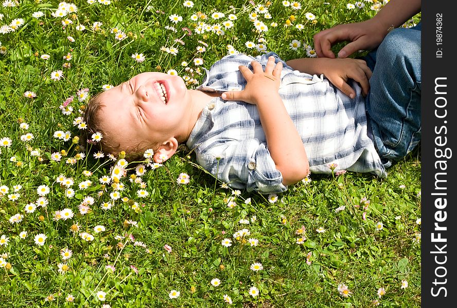 Little boy laying in the grass