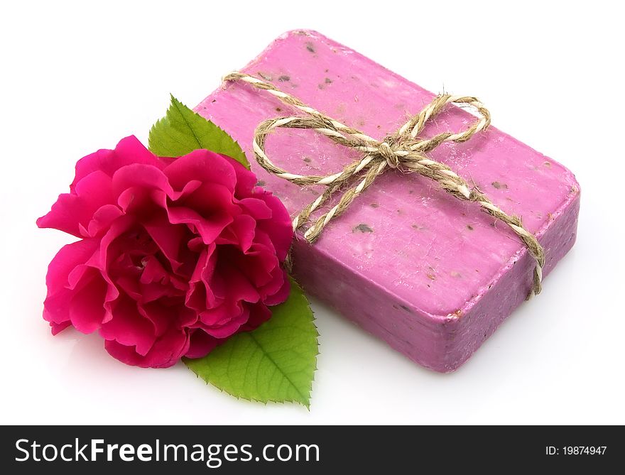 Pink soap with rose on white