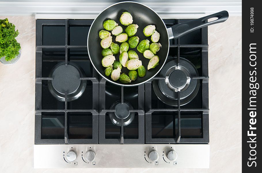 Vegetables dish prepared in a black skillet in the kitchen. Vegetables dish prepared in a black skillet in the kitchen