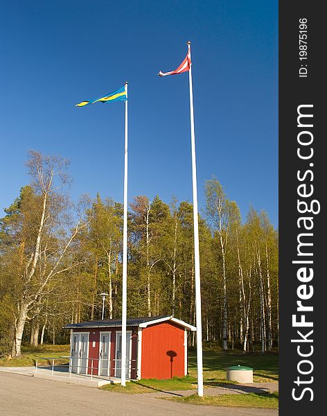 Flag of Sweden and Denmark on the background of the park