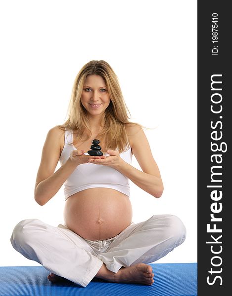 Pregnant woman holding pile of stones isolated on white