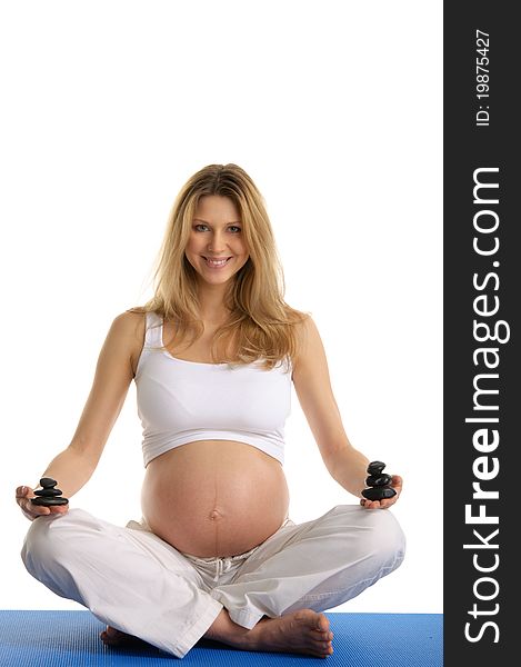 Pregnant woman with hill of stones isolated on white