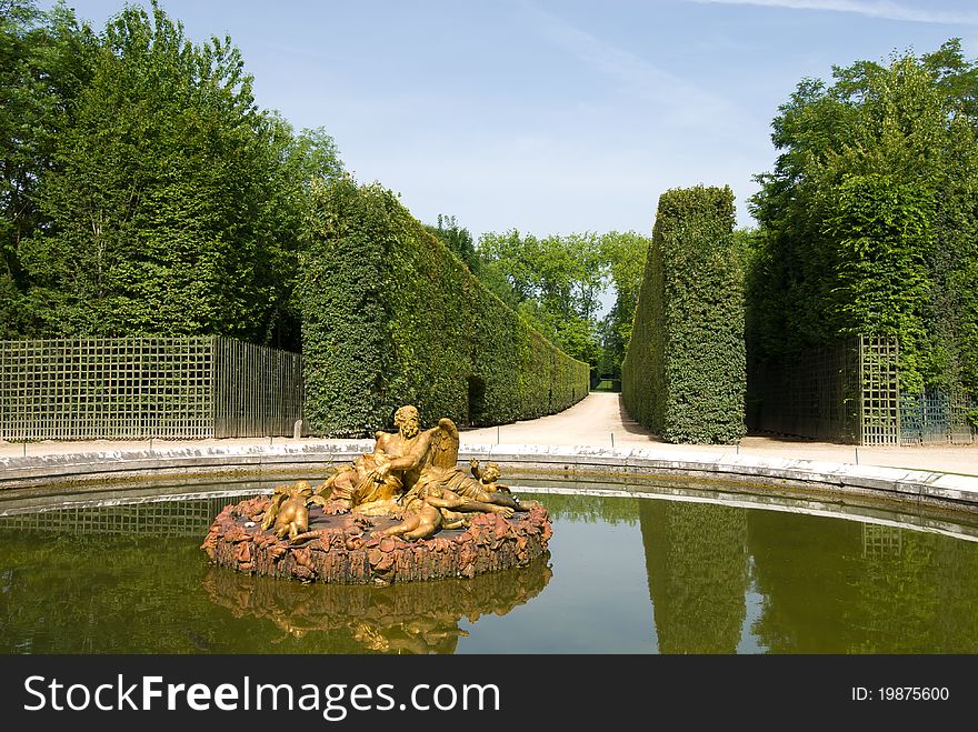 Bassin de Saturne fountain in Versailles Palace garden, city Paris, France. The Palace Versilles is a royal chateau, It was added to the UNESCO list of World Heritage Sites in 1979.