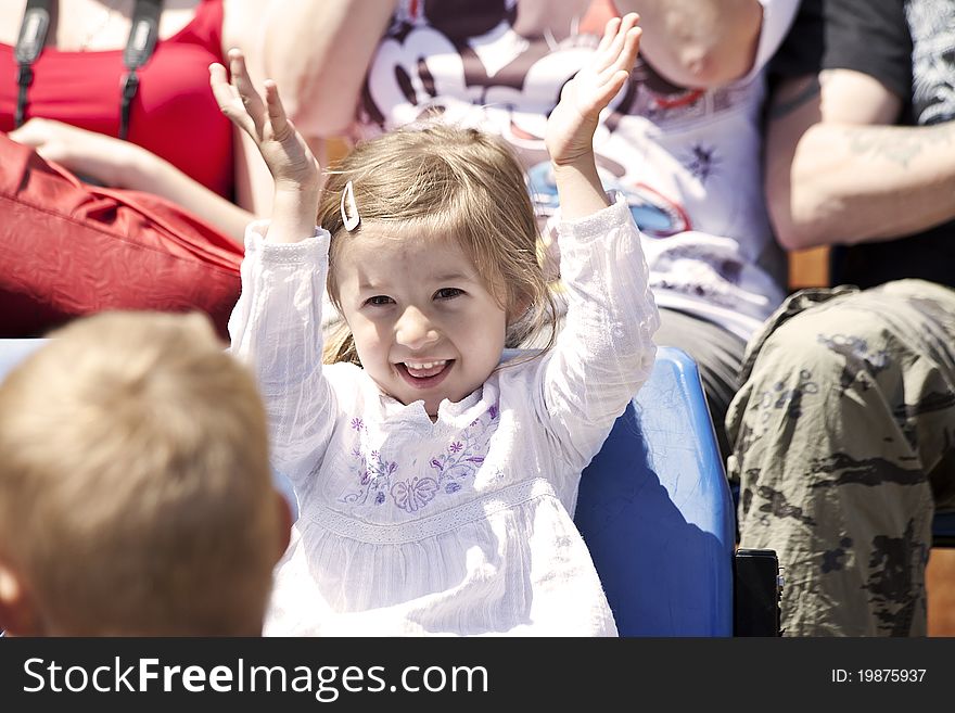 Happy girl watching show and clapping her hands