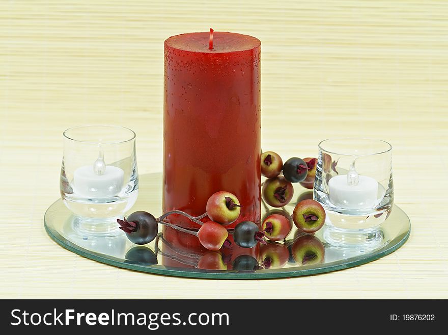 Beautiful home decoration with candle and decorative flower on small brown bamboo rug