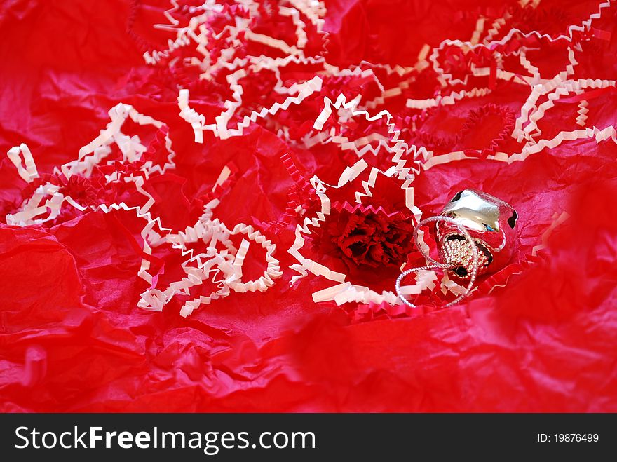 Christmas bell and red carnation on red and white background. Christmas bell and red carnation on red and white background