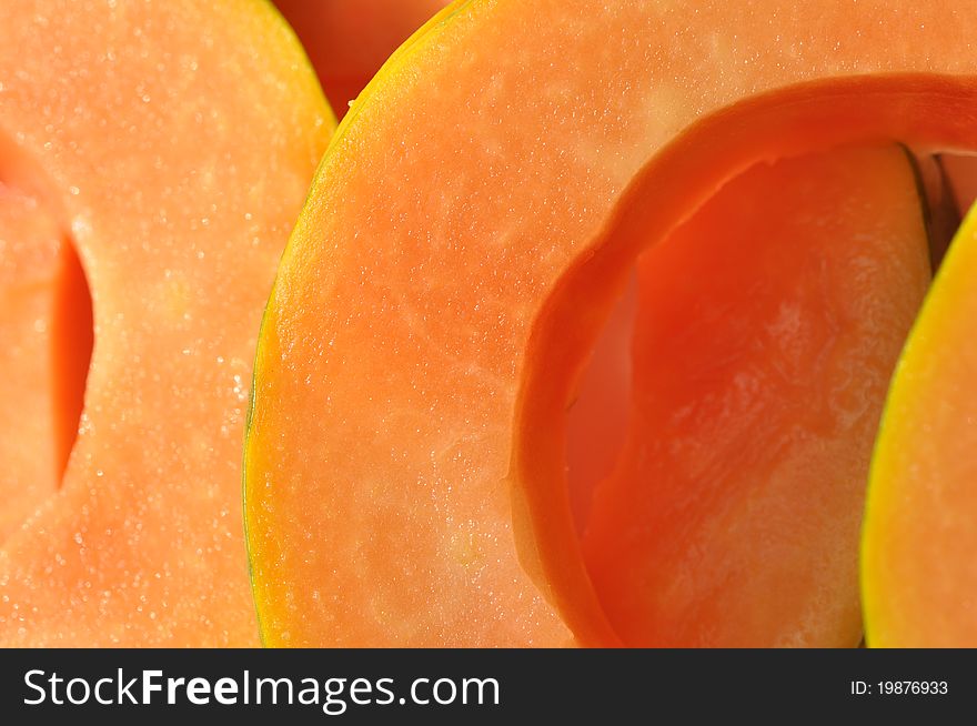 Close up a slices of bright orange papaya. Close up a slices of bright orange papaya