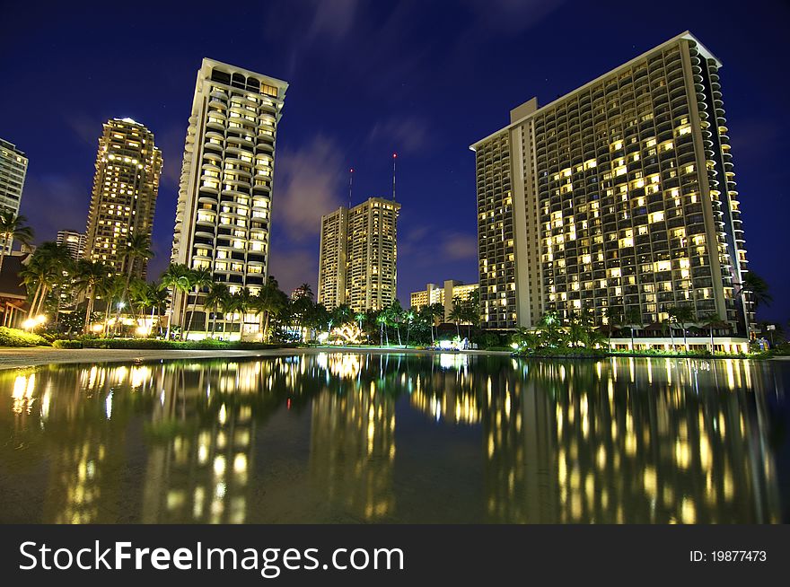 Hotels on Waikiki beach on the island of Oahu in Hawaii with a reflection on the water. Hotels on Waikiki beach on the island of Oahu in Hawaii with a reflection on the water.