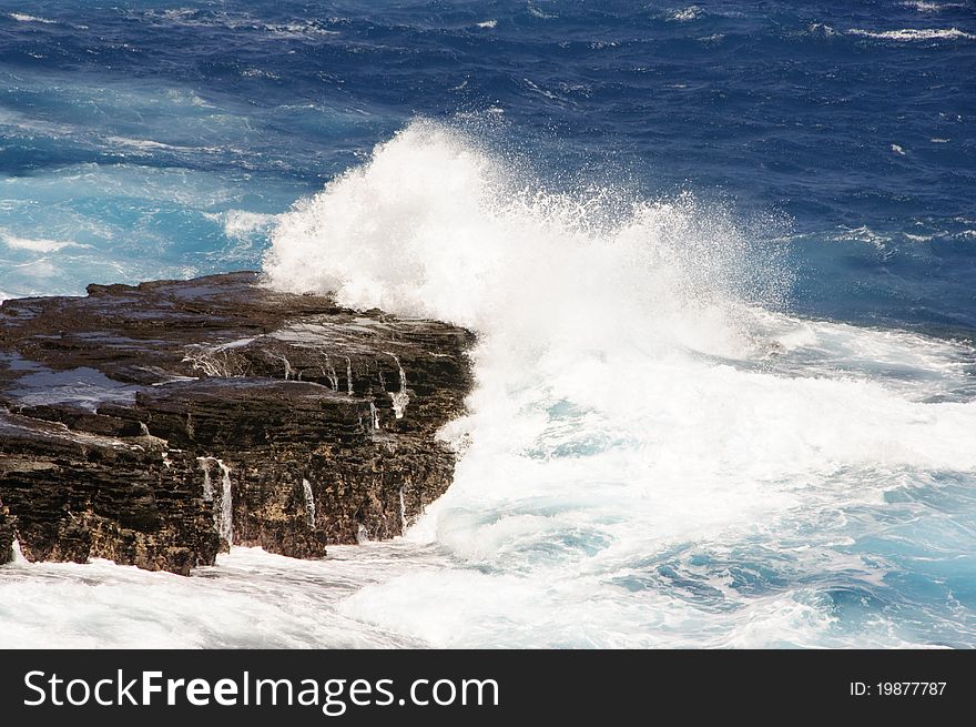 Waves splashing on the lava rock coast in Hawaii on the Island of Oahu. Waves splashing on the lava rock coast in Hawaii on the Island of Oahu.