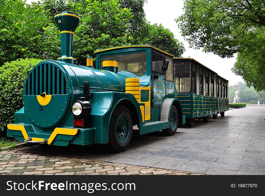 green and yellow tourist coach in a park