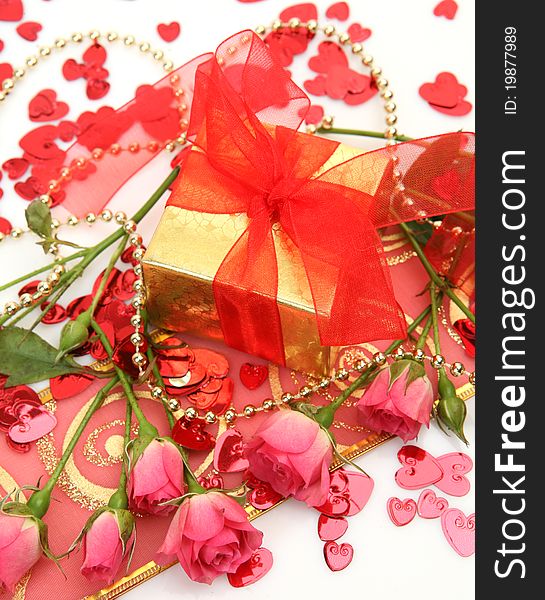 Gift and roses on a white background