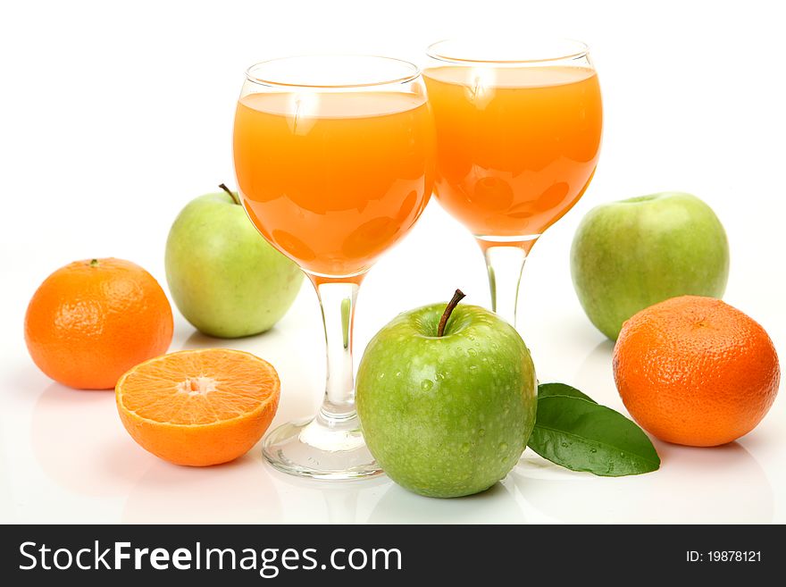 Fresh fruit and juice on a white background
