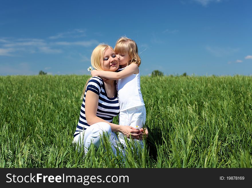 Mother with her daughter outdoors in summer day