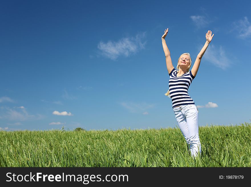 Young blond woman in blue dress in the park. Young blond woman in blue dress in the park