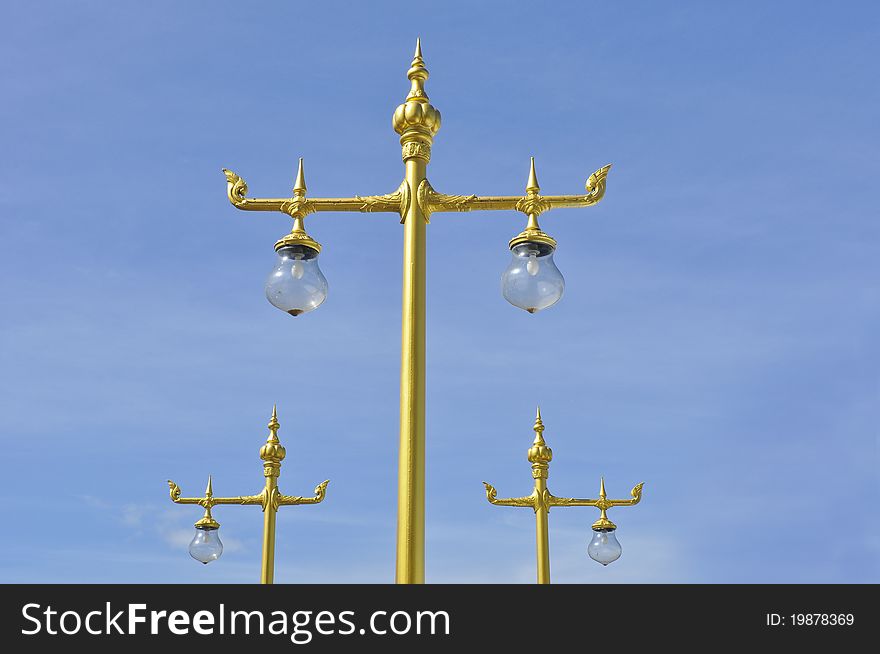 Golden Thai street lamp with blue sky