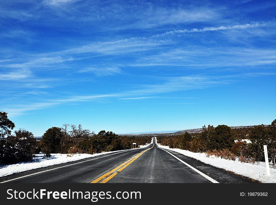 An unknown US highway surrounded by snow-covered atmosphere. An unknown US highway surrounded by snow-covered atmosphere