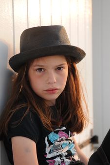 Young Girl Wearing Black Hat Against Beach Cabin Royalty Free Stock Photography Young Girl Wearing Black Hat Against Beach Cabin Royalty Free Stock Photography