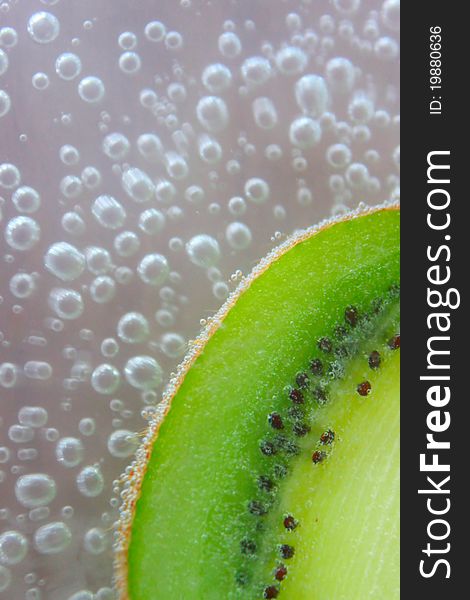 Fresh slice of kiwi in soda with space for text. Fresh slice of kiwi in soda with space for text.