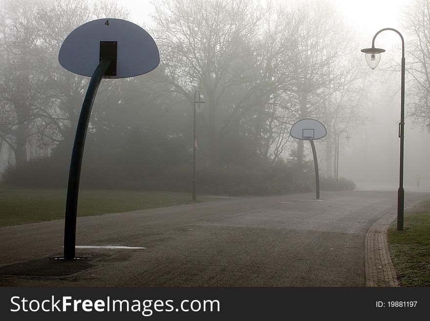 Basketballpark in the mist early in the morning. Basketballpark in the mist early in the morning
