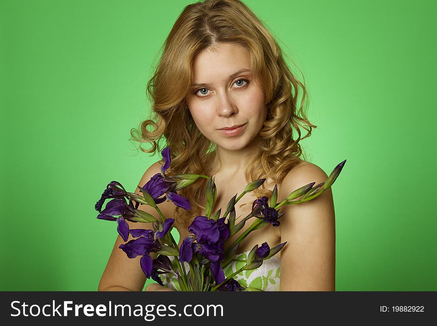 Attractive girl hugging a bouquet of iris