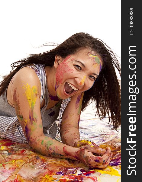 A woman having fun laying in paint, she has a big smile on her face. A woman having fun laying in paint, she has a big smile on her face.