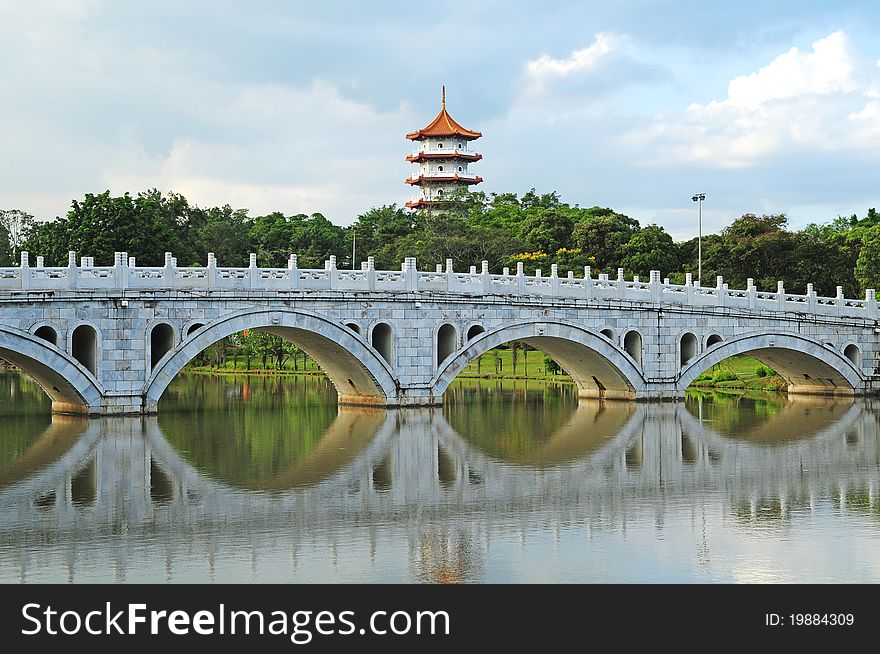 Chinese Styled Garden With Pagoda And Curve Arch Bridge. Chinese Styled Garden With Pagoda And Curve Arch Bridge