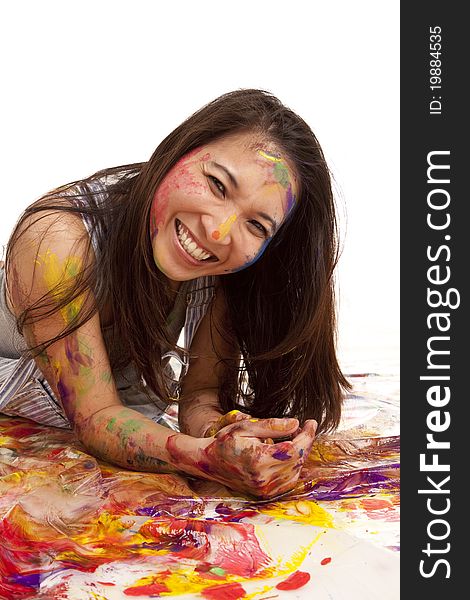 A woman laying in paint with a happy expression on her face. A woman laying in paint with a happy expression on her face.