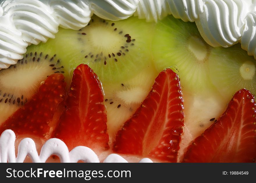 Sweet cake dessert with strawberries, kiwi fruit, jelly, cream