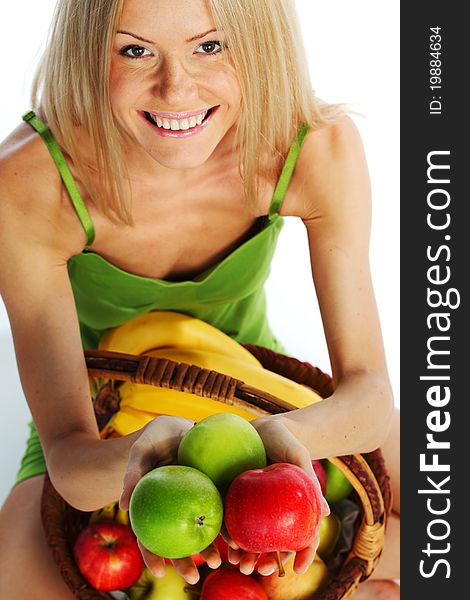 Woman holds a basket of fruit on a white background