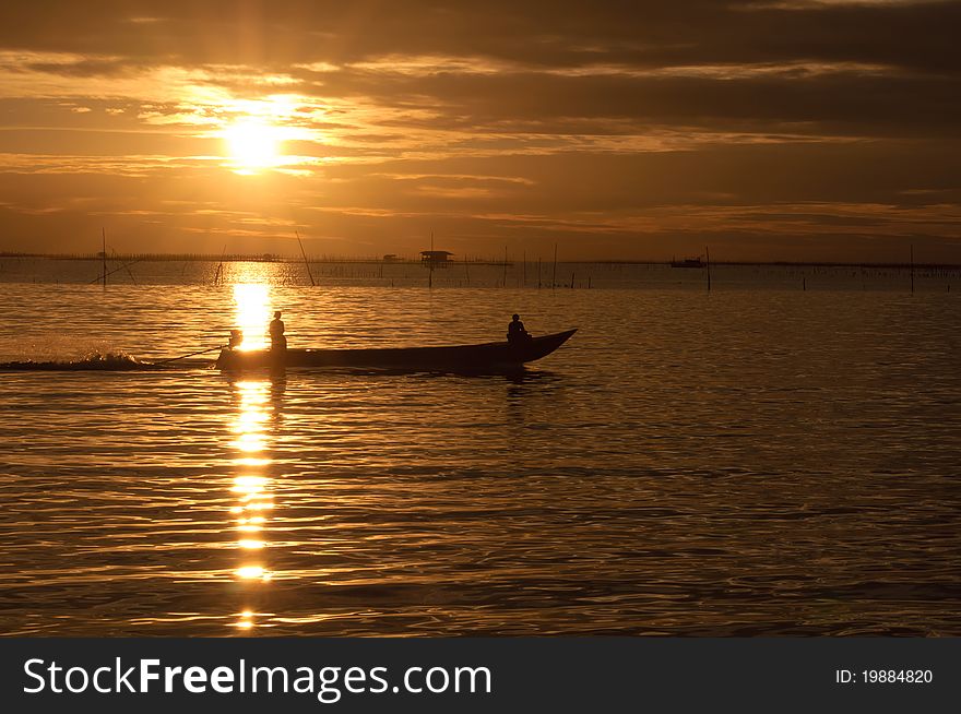 Fishermen boat in sunset