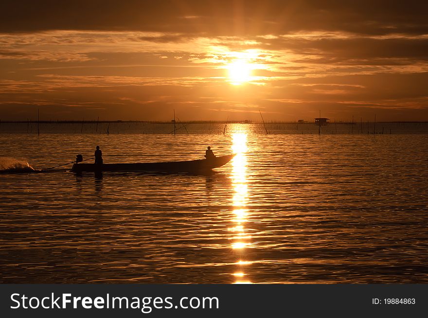 Fishermen boat in sunset