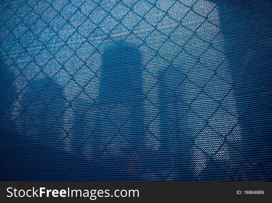 Blue curtain as a screen of a large construction site. Blue curtain as a screen of a large construction site