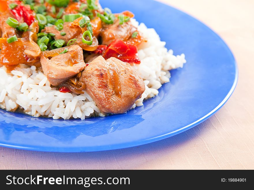 Grilled meat with vegetables and rice on a plate