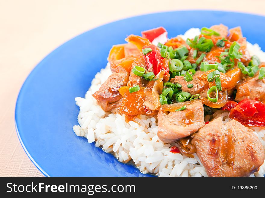 Grilled meat with vegetables and rice on a plate