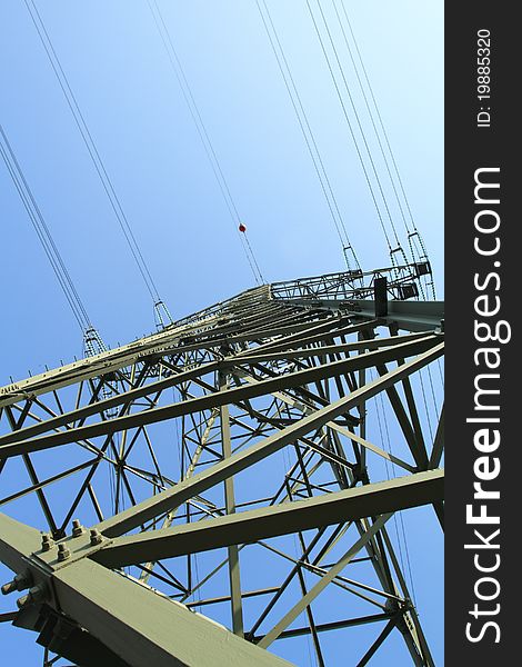 Detail of electricity pylon against blue sky