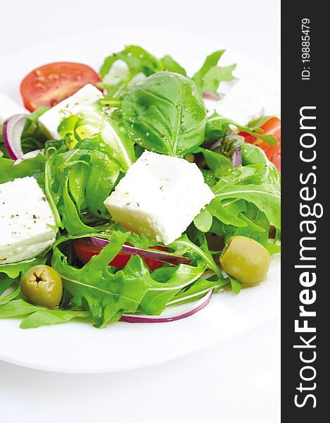 Healthy vegetarian salad on a plate on a white background. Healthy vegetarian salad on a plate on a white background