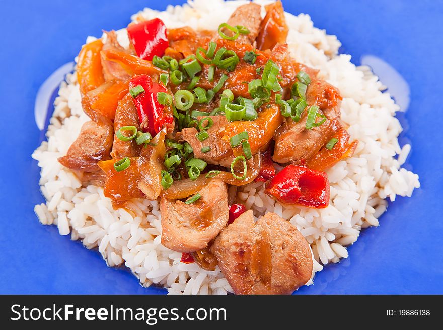 Grilled meat with vegetables and rice on a plate