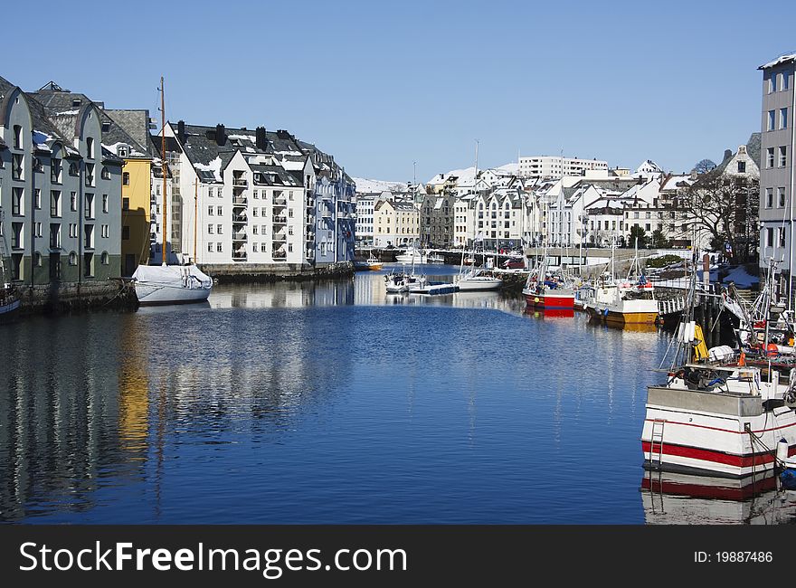 The colourful sea inlet at Alesund, Norway, complete with boats and lovely buildings. The colourful sea inlet at Alesund, Norway, complete with boats and lovely buildings.